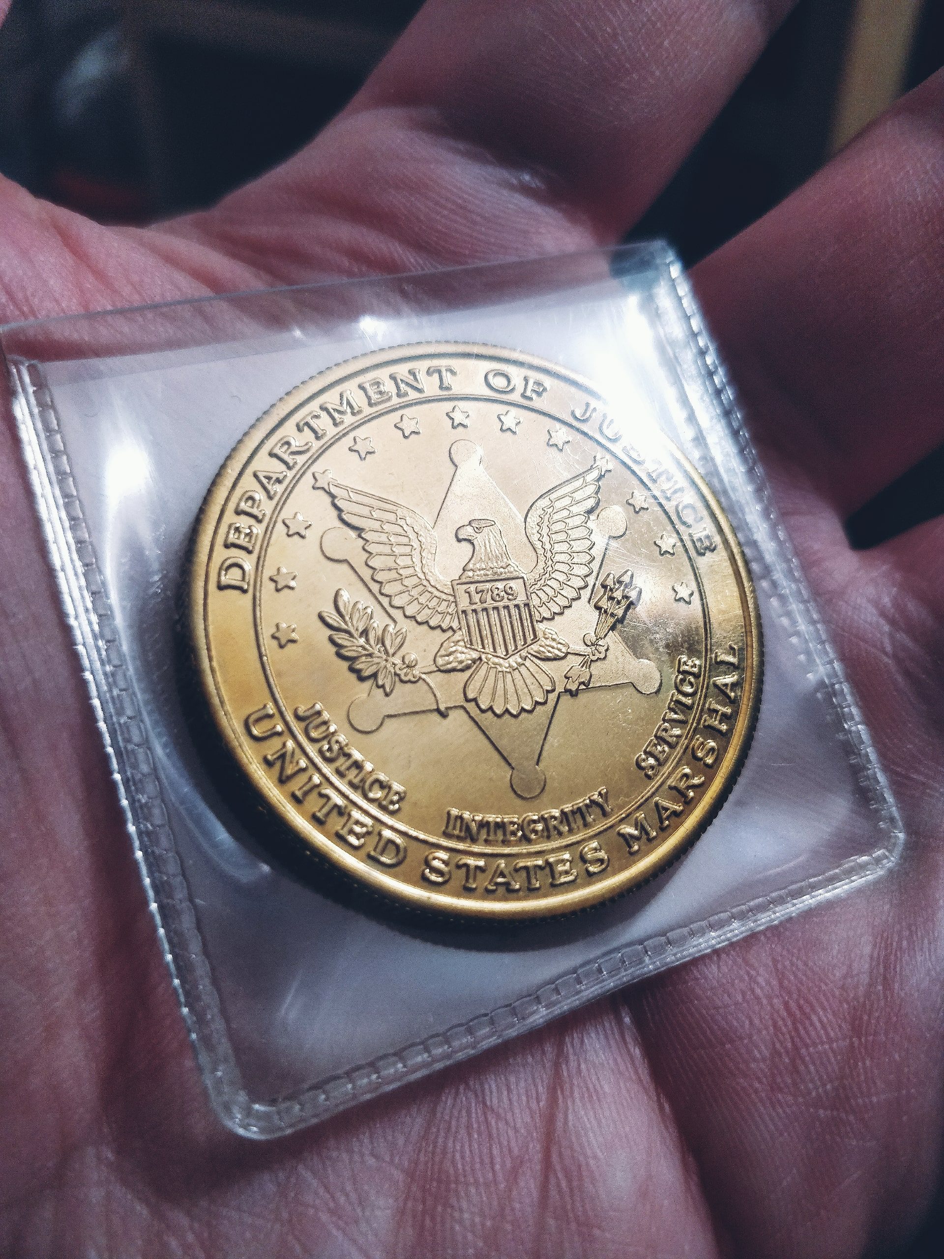 hand holding police challenge coin